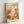 May include: Framed poster print leaning against white wall showing stylized autumn forest scene with orange, brown and cream colored mushrooms, trees and foliage in modern illustration style. Features Japanese text and "JAPAN 1987" at top. Light wood frame on neutral background with soft natural lighting.