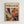 The image is a framed poster with a vibrant abstract painting featuring swirling colors and shapes.