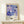 a framed poster of a colorful abstract floral design, hanging on a wall above a small white table.