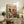a framed poster of a colorful abstract painting, which is displayed on a wooden cabinet or shelf in a living room setting.