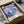 A framed poster of a colorful abstract floral design is displayed in a cardboard box.