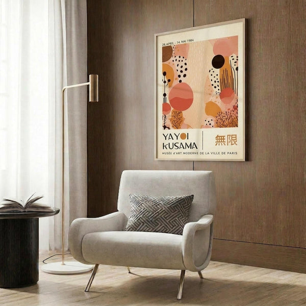 a modern living room with a white armchair, a floor lamp, and a framed poster on the wall.