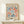 a framed poster of the Métisse art movement, specifically the "Papiers Découps" series, displayed on a white shelf.