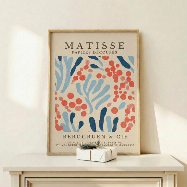 a framed poster of the Métisse art movement, specifically the "Papiers Découps" series, displayed on a white shelf.