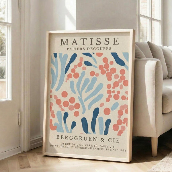 A framed poster of the Métisse art movement, featuring a floral pattern in shades of blue, pink, and orange.