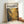 a framed poster with a striking abstract painting in gold and black colors.