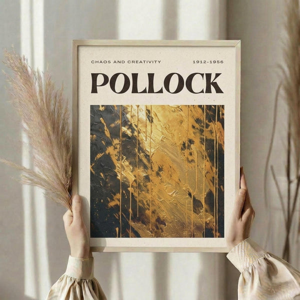 A person's hands holding a framed print with the title "POLLOCK" and the text "CHAOS AND CREATIVITY 1912-1956" printed on it.