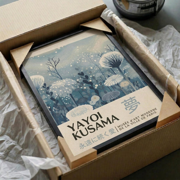 A framed poster of a floral design with text, placed in a cardboard box.