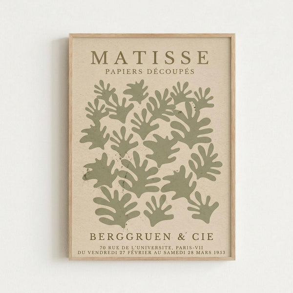 The image is a framed poster featuring a repeating pattern of green leaf-like shapes, with text providing information about the artist and the location of the artwork.
