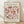 The image is a poster for the painting "Matisse: Papiers Decoupes" by the artist Berg Gruen & Cie. The poster features a floral pattern in shades of pink and brown, and it is displayed on a wooden floor against a white wall.