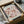 a framed poster of the work "MATISSE" by the artist Frida Cie, which is a large floral print. The poster is displayed in a cardboard box, and there is a clear plastic sleeve on the box.