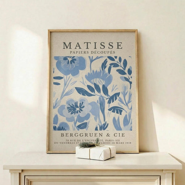 a framed poster of the famous painting "Matsisse" by the artist Henri Matisse, which is displayed on a white shelf.