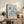 a framed poster of the famous painting "Matsisse" by the artist Edouard Manet, displayed on a wooden shelf in a living room setting.