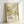 The image is a framed poster or artwork featuring a colorful abstract design with a floral pattern and the text "YAYOI KUSAMA" and "MUSEÉD'J'ART MODÉRÉE DE LA VILLE AT PARIS" on it.