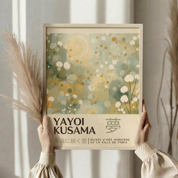 A person's hands holding a framed poster with a colorful abstract design and text.