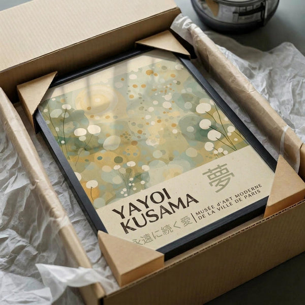a framed poster or artwork titled "YAYOI KUSAMA" displayed in a cardboard box.