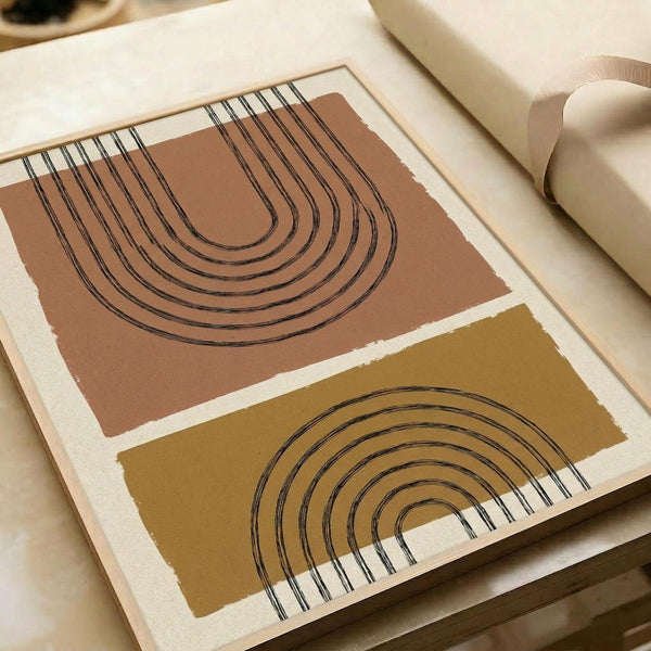 May include: Abstract geometric art print featuring two curved arch designs in terracotta brown and mustard yellow color blocks with black concentric line details, displayed in a light wood frame on a cream-colored surface next to neutral fabric and decorative objects in warm, natural lighting.