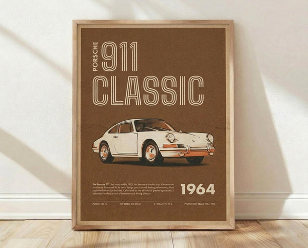May include: Framed vintage-style poster with brown background featuring cream-colored Porsche 911 illustration, bold retro typography reading "911 CLASSIC" and "1964", technical specifications at bottom, displayed in light wooden frame against white wall on wooden floor with natural window lighting creating soft shadows