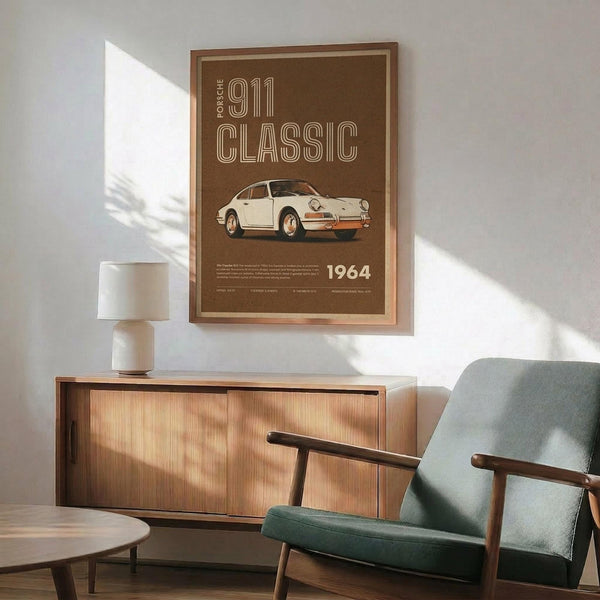 May include: Brown vintage-style poster featuring classic white Porsche 911 sports car with "PORSCHE 911 CLASSIC" text and "1964" date, displayed in wooden frame above mid-century modern walnut credenza with white ceramic table lamp, next to sage green upholstered armchair with wooden arms in bright sunlit room with white walls and dramatic window shadows.
