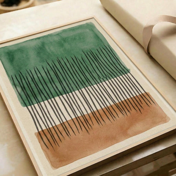 Abstract minimalist artwork featuring vertical black lines of varying heights against a watercolor background with green wash in the upper portion and warm brown tones below. The piece is displayed as a print with white border matting, lying flat on a neutral surface alongside rolled paper tubes, showing the artwork's clean geometric design and organic color transitions.