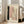 May include: Large framed abstract art print leaning against white wall next to beige upholstered chair. Artwork features soft pink and sage green rectangular shapes, black brushstroke, row of dark dots, and curved line on cream background. Natural light streams through tall windows onto wooden floor.