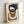 May include: Framed abstract geometric artwork leaning against white wall. Features overlapping organic shapes in navy blue, terracotta brown, and cream on textured beige background. Natural wood frame with visible grain. Soft natural lighting creates subtle shadows on wall and frame surface.