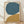 May include: Framed abstract art print featuring two large organic shapes - a teal blue circular form above and a golden mustard curved shape below - painted on cream background. Visible brushstrokes and texture throughout. Natural wood frame leaning against white wall on light wooden floor with soft shadows.