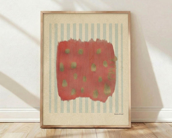 May include: Framed abstract art print leaning against white wall on light wood floor. Features red brushstroke shape with scattered olive green dots over soft blue and cream vertical stripes on cream background. Natural wood frame, soft window light casting shadows across white textured wall.