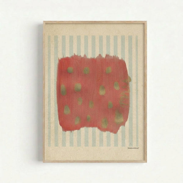 Abstract artwork in light wood frame featuring a coral-red brushstroke shape with olive green dots scattered across it, set against pale blue and cream vertical stripes on textured cream background, mounted on white wall