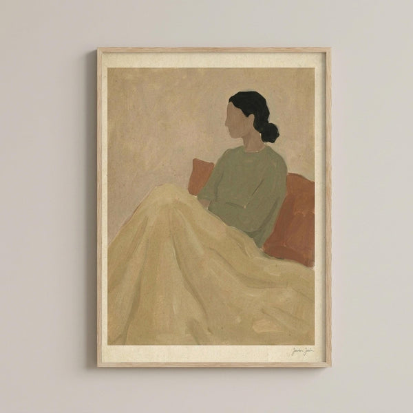 May include: Minimalist illustration artwork in light wooden frame hanging on white wall. Shows woman in profile with dark hair in bun, wearing sage green top and cream colored flowing skirt or blanket, seated against warm terracotta background. Muted earth tone palette with soft, painterly style and visible paper texture.