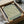 May include: Framed vintage botanical print featuring intricate green willow leaves on cream background, displayed in black frame inside cardboard shipping box with tissue paper and bubble wrap packaging materials visible around it.