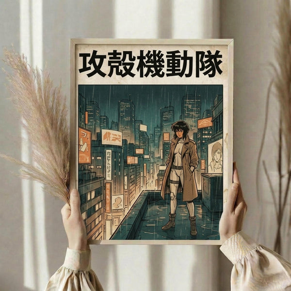 May include: Hands holding a framed anime-style poster featuring a female character in a brown coat standing on a rain-soaked city street at night. The artwork shows tall buildings with glowing windows, neon signs with Japanese text, and a moody teal and orange color palette. The poster has Japanese characters at the top and is displayed in a light wooden frame. Dried wheat stalks are visible on the left side, and the scene is photographed against white curtains in natural lighting.