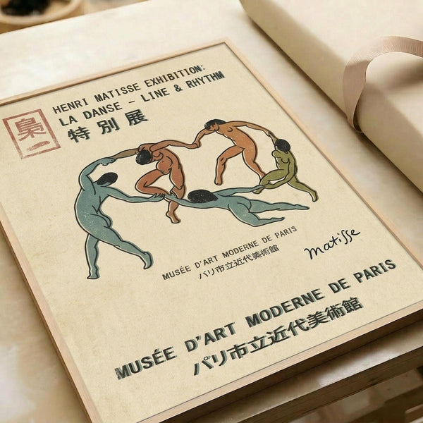 Exhibition poster featuring Henri Matisse's "La Danse" with flowing dancers in blue, orange, and green tones forming a circle. Text includes "Henri Matisse Exhibition: La Danse - Line & Rhythm" and "Musée d'Art Moderne de Paris" in both English and Japanese characters. Matisse signature visible on cream-colored paper with thin border, shown flat against white fabric background.