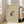 May include: Framed vintage-style artwork featuring a spotted frog illustration with Japanese characters, displayed in a light wooden frame against a beige armchair in a bright, naturally-lit room with white walls and large windows.