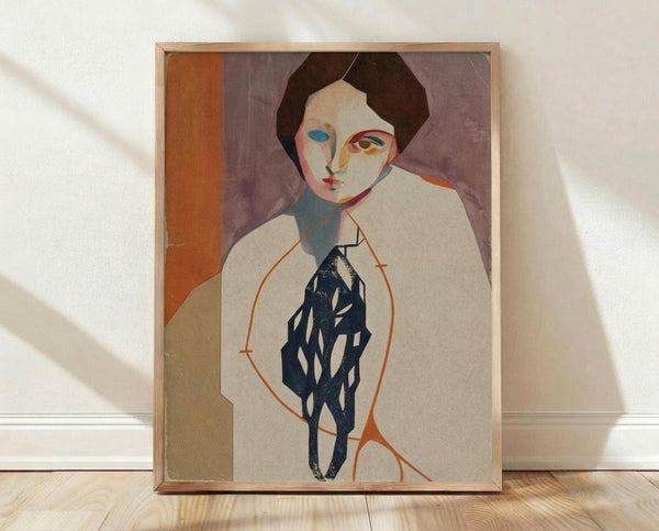 May include: Framed modernist portrait poster leaning against white wall on light wood floor. Abstract figure with dark hair, asymmetrical face in muted tones - purple background, orange geometric shapes, blue and white figure holding dark patterned object. Simple wood frame, soft natural lighting creates gentle shadows on textured white wall.