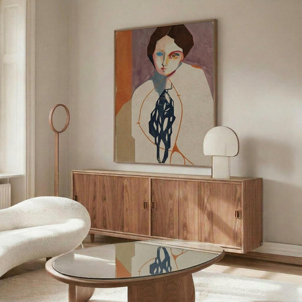 May include: Modern living room interior with abstract portrait artwork on wall above wooden sideboard. Painting features stylized figure with geometric face in warm tones of orange, purple, and navy blue. Room has cream walls, white upholstered chair, glass coffee table, and contemporary lighting fixtures creating bright, minimalist space.