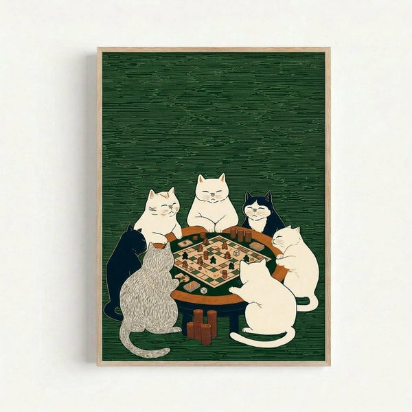 Five cats sitting around a circular wooden table playing a board game on a green textured background. The cats include cream, white, black and white, and gray tabby varieties, all with content expressions. The game board appears to be chess or checkers with game pieces and dice visible. Stacks of poker chips or tokens are scattered around the table. The artwork is displayed in a light wood frame against a white wall in a clean, minimalist room setting.