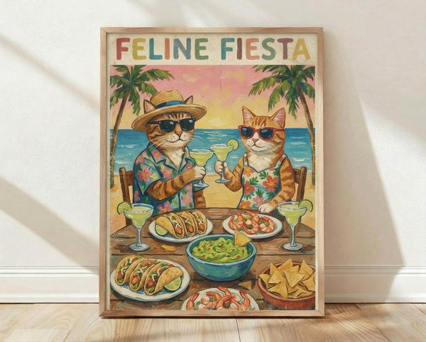 May include: Framed poster print leaning against white wall on light wood floor. Artwork shows two cartoon cats in sunglasses and Hawaiian shirts toasting margaritas at beach table with tacos, guacamole, chips and Mexican food. Tropical beach scene with palm trees and pink sunset sky. Colorful rainbow text reads "FELINE FIESTA" at top. Natural wood frame, vintage-style illustration.