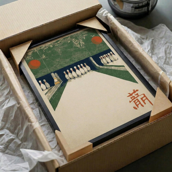 May include: Vintage Japanese woodblock print artwork featuring a green and blue bowling alley scene with white bowling pins, red circular elements, and Japanese characters in red. The framed print sits in an open cardboard shipping box surrounded by white tissue paper, with wooden dowels visible alongside. The artwork shows a modernist geometric style with bold color blocks and angular composition.