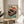 May include: Framed vintage-style Japanese poster featuring red turntable with vinyl record, orange sunset, cherry blossoms, and bonsai trees in retro art style. Displayed on round wooden side table next to beige upholstered chair and plant in bright, minimalist room with white walls and natural lighting.