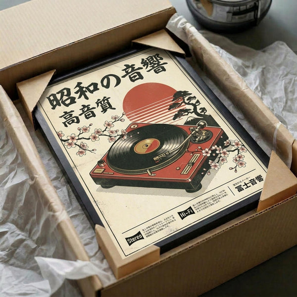 May include: Vintage-style poster featuring red turntable with cherry blossoms and Japanese text, displayed in black frame inside cardboard shipping box with protective padding. Cream-colored artwork shows retro record player against rising sun backdrop with delicate pink sakura branches. Package sits on white tissue paper with additional protective materials visible.