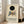 May include: Framed exhibition poster featuring abstract geometric composition with black circle, blue triangles, yellow rectangles, gray shapes, and red lines on cream background. Text reads "KANDINSKY TATE BRITAIN EXHIBITION" with venue details. Light wood frame leaning against white wall next to beige sofa in bright, minimalist living room with large windows and natural lighting.