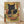 May include: Framed poster print leaning against white wall on wooden floor. Artwork shows black cat with golden eyes using chopsticks to eat ramen noodles from red bowl with Japanese characters. Bowl contains noodles, sushi rolls, and dumplings. Background features geometric patterns in earthy tones of gold, green, and rust with Japanese text panels. Light wood frame, vintage-inspired illustration style with detailed linework and warm color palette.