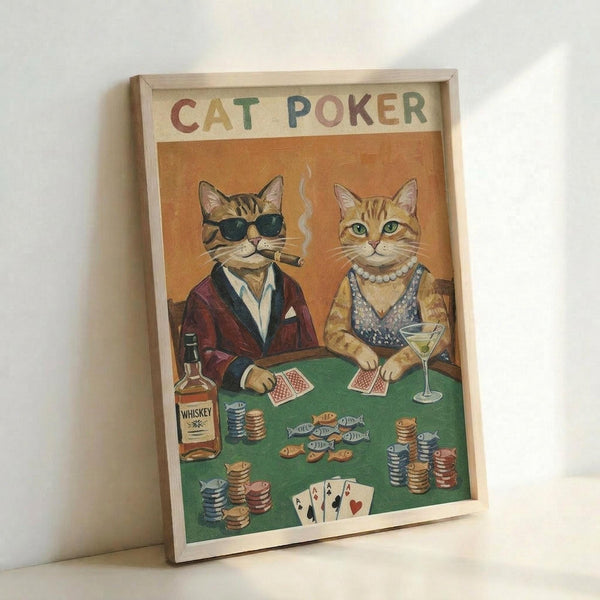 May include: Framed poster print leaning against white wall showing two anthropomorphic cats playing poker at green felt table. Left cat wears sunglasses, burgundy jacket, smoking cigar while holding cards. Right cat wears pearl necklace, patterned vest, holds martini glass. Poker chips, whiskey bottle, and fish-shaped snacks scattered on table. Four aces visible. Warm orange background with vintage illustration style in light wood frame.