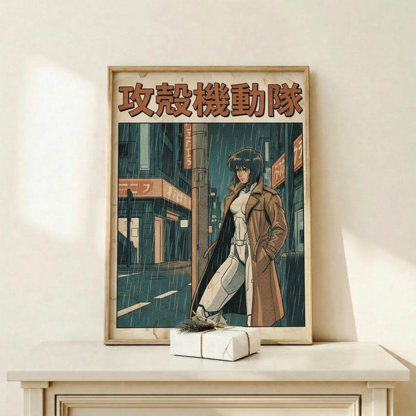May include: Framed anime poster showing a woman with dark hair in a brown coat standing on a rainy cyberpunk street with neon signs and tall buildings. The poster features Japanese text at the top and is displayed in a light wood frame on a white shelf next to a small wrapped gift box against a cream colored wall.