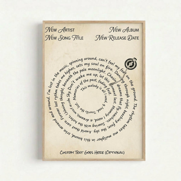 A framed poster with cream background featuring placeholder text in elegant black script font arranged in a circular spiral pattern around a small vinyl record icon. The text includes "New Artist," "New Album," "New Song Title," and "New Release Date" at the top, with sample song lyrics flowing in a circle below. Custom text area appears at bottom. Light wood frame against white wall.