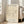 May include: Framed beige poster with black line drawing of a bull in minimalist style, displayed on hardwood floor next to beige sectional sofa in bright living room with white walls and large windows. Natural wood frame complements neutral interior design with soft natural lighting.