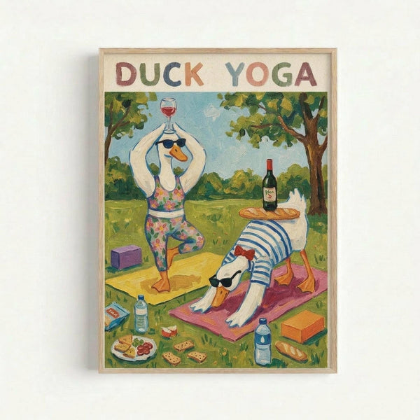 Framed art print showing two cartoon ducks doing yoga in a park setting. One duck wearing floral yoga pants and sunglasses stands in tree pose holding a wine glass, while another duck in a striped shirt does downward dog pose on a pink yoga mat. The scene includes yoga blocks, water bottles, a picnic spread with bread and cheese, wine bottle, and green trees in the background. Colorful hand-painted style illustration in natural wood frame.
