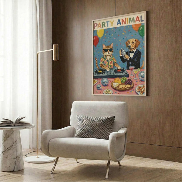 May include: Colorful poster artwork displayed on wood-paneled wall above beige upholstered chair with geometric pillow. Shows cartoon cat DJ at turntables and dog in tuxedo holding cocktail shaker at party with balloons, confetti, and food spread on pink table. Modern living room setting with marble side table, gold floor lamp, and hardwood floors.