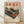 May include: Framed vintage-style Japanese poster featuring red turntable with vinyl record against cream background with cherry blossoms, Mount Fuji, and traditional trees. Red Japanese characters at top, katakana text below. Technical specifications in Japanese at bottom with company logo. Natural wood frame displayed on light wooden floor against white wall with soft shadows.